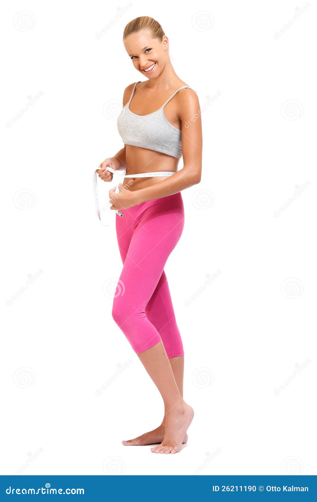 Young barefoot woman in leggings and pullover stretching legs