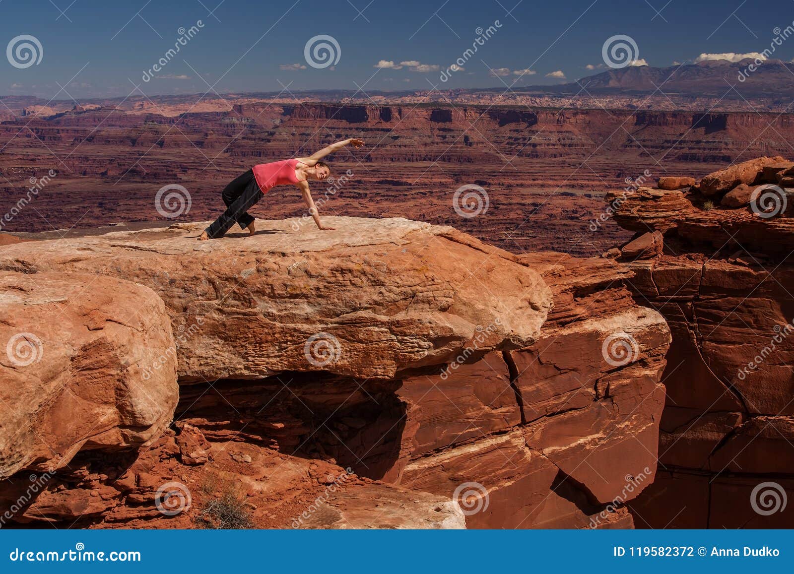Woman Meditating And Relaxing On Mountain Top. Stock Photo 