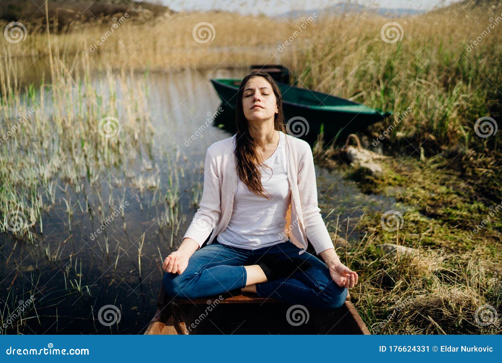 woman meditating in nature.escape from stressful reality.mindful woman practicing meditation.breathing technique.mental state