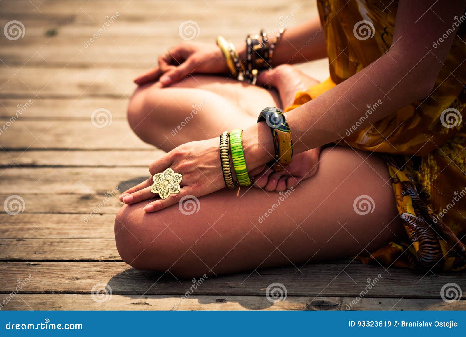 woman in a meditative yoga position outdoor lower body
