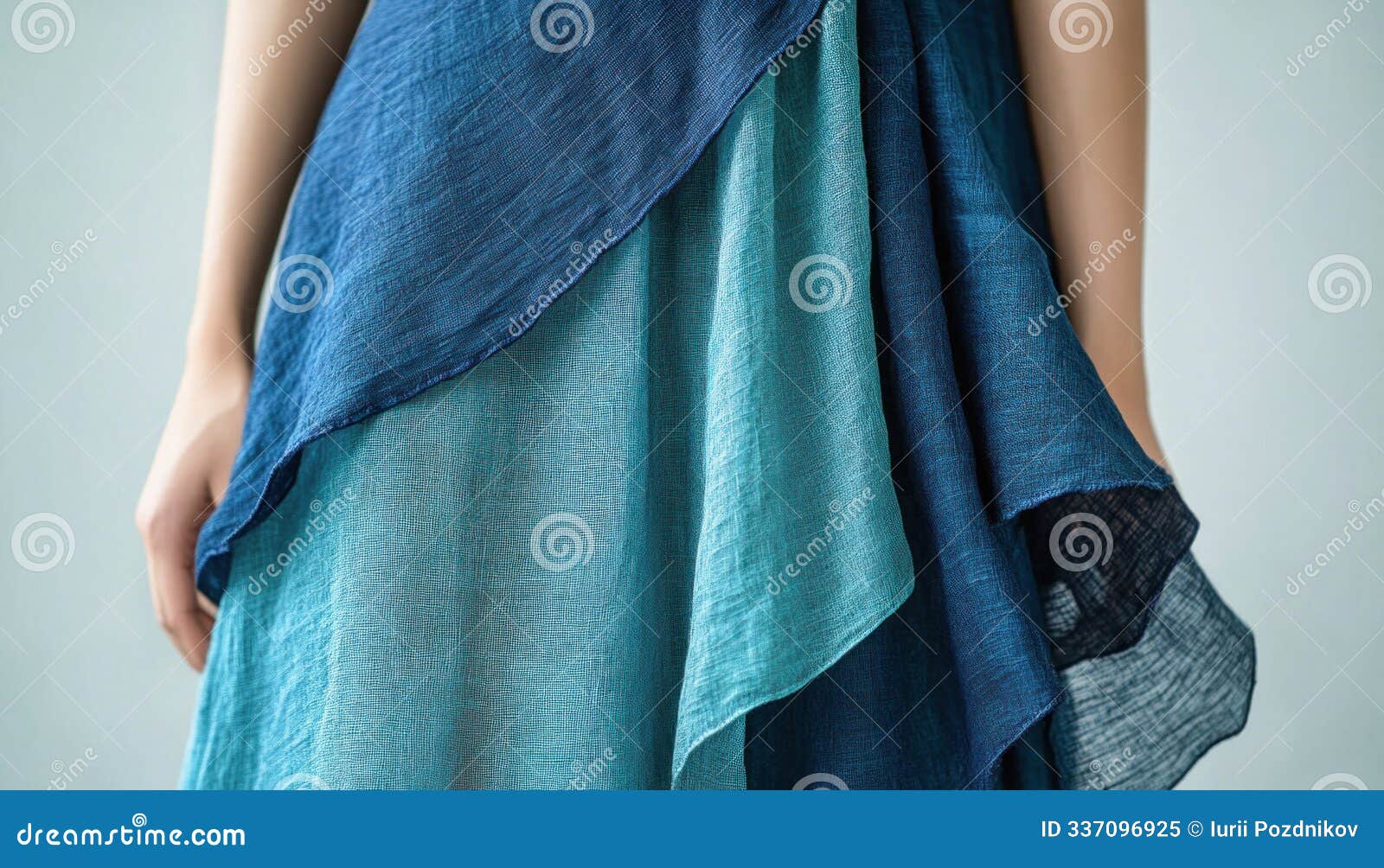 woman wearing blue dress with multiple layers of fabric