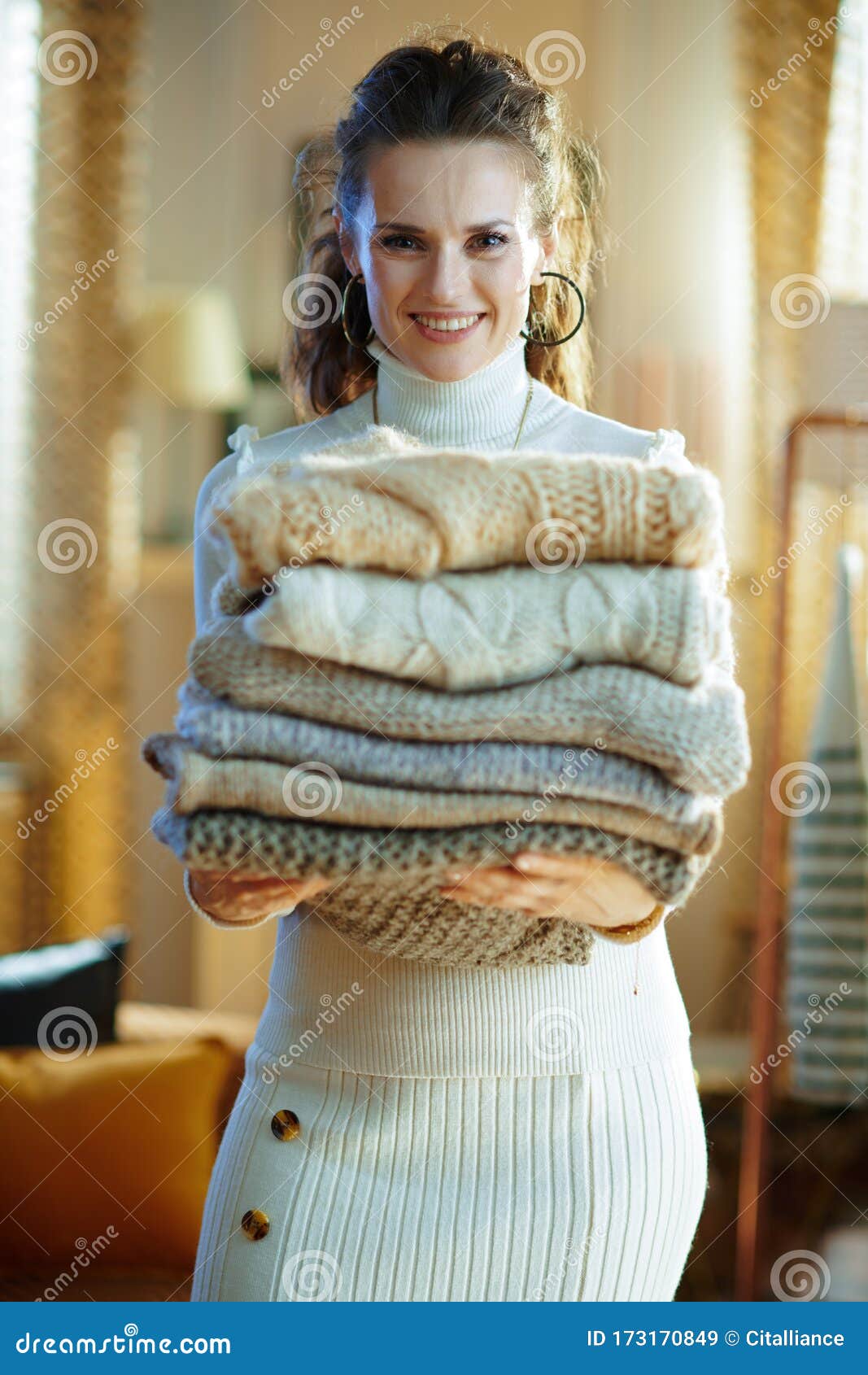 Woman in Modern House in Sunny Winter Day Holding Sweaters Stock Image ...