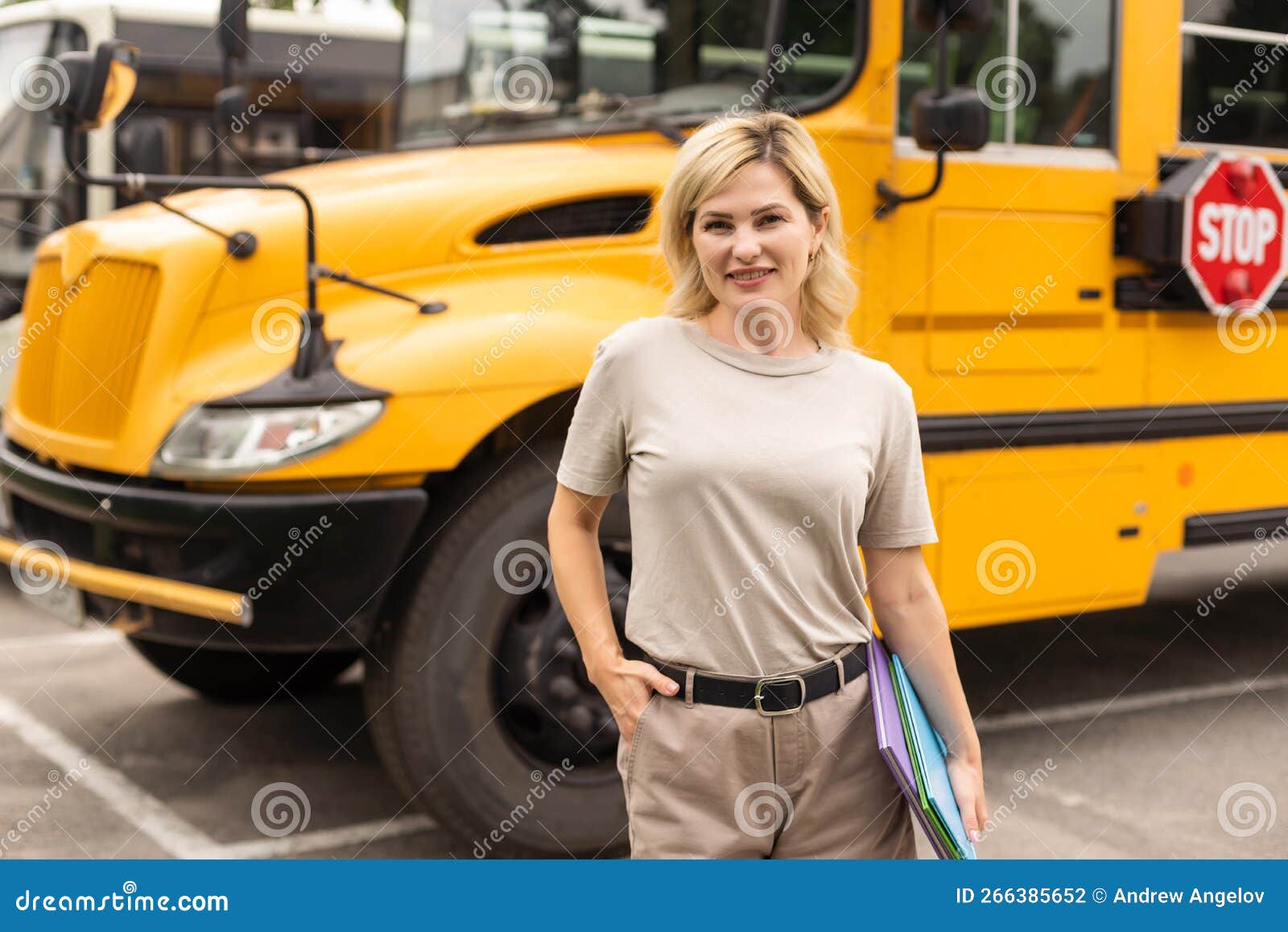 A woman near a school bus stock photo. Image of fashion 266385652