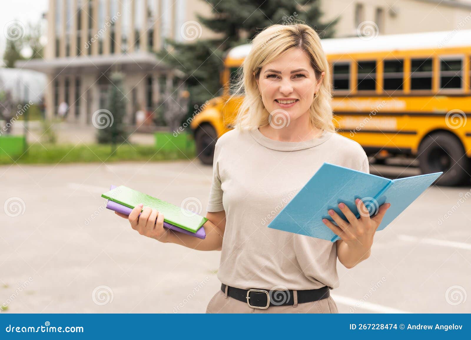 A woman near a school bus stock photo. Image of glasses 267228474