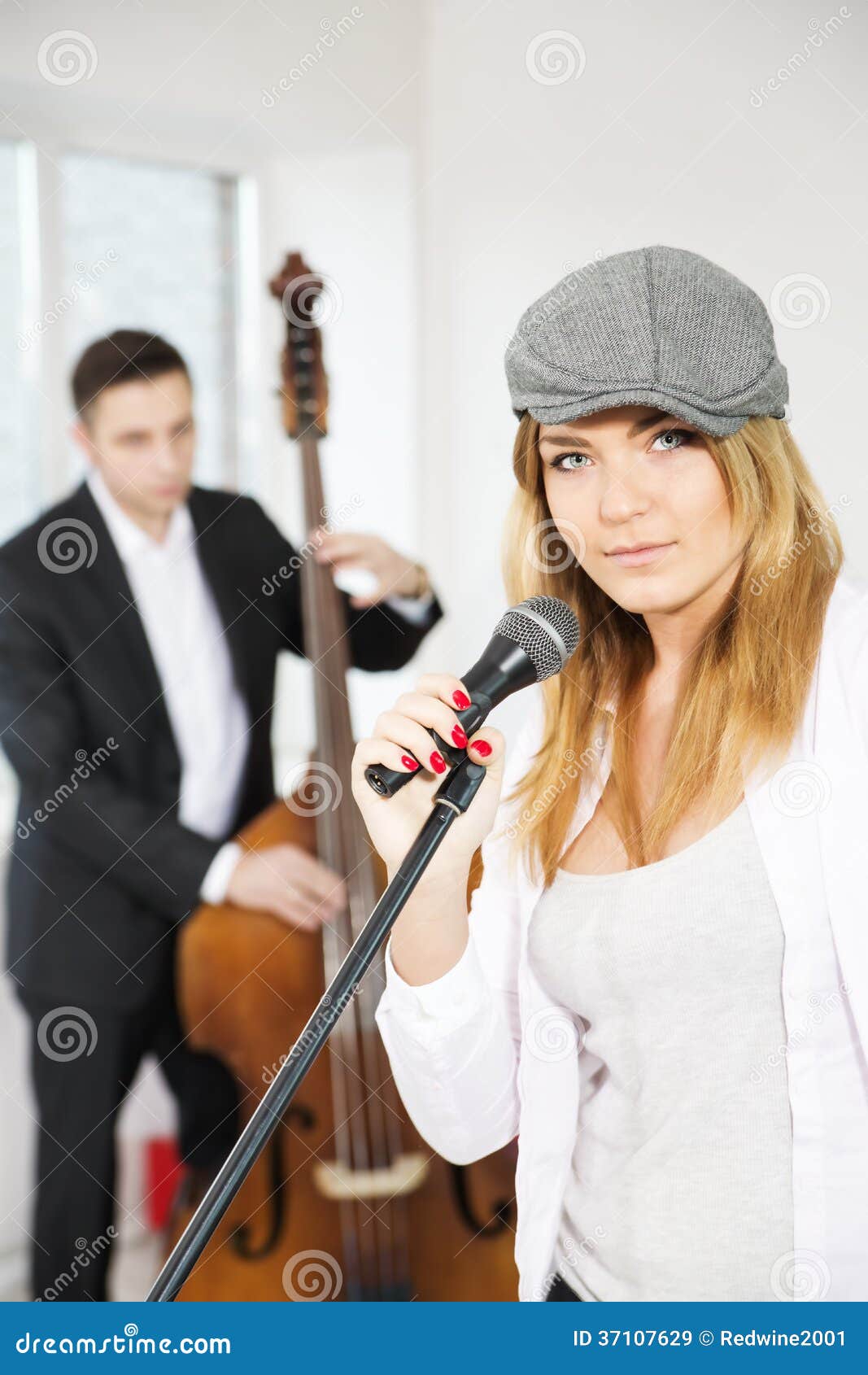 woman next to microphone and contrabas