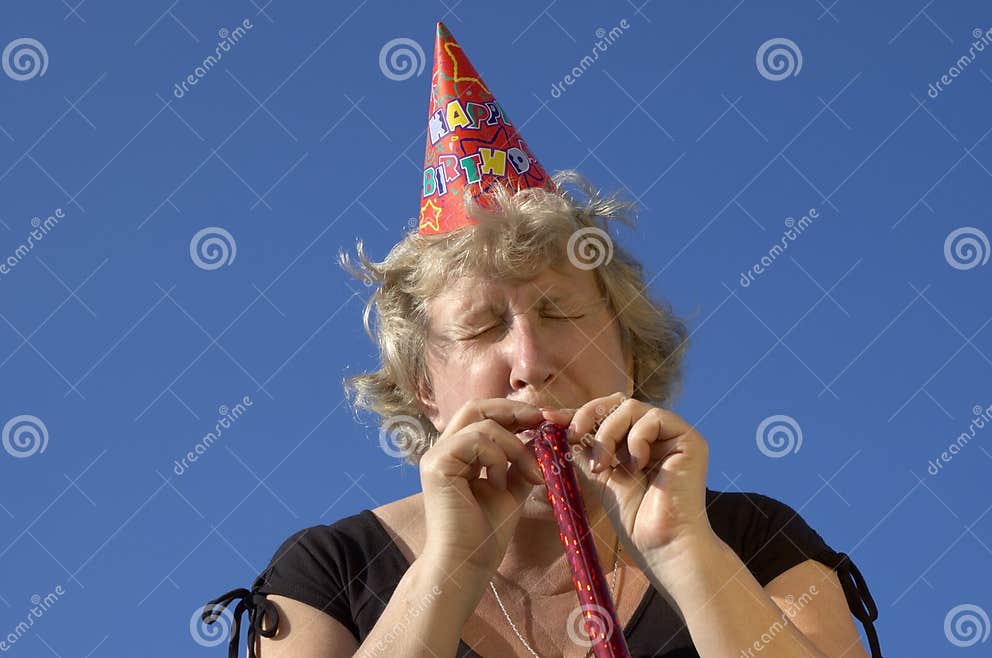 Woman with Noisemaker on the Party Stock Photo Image of blow
