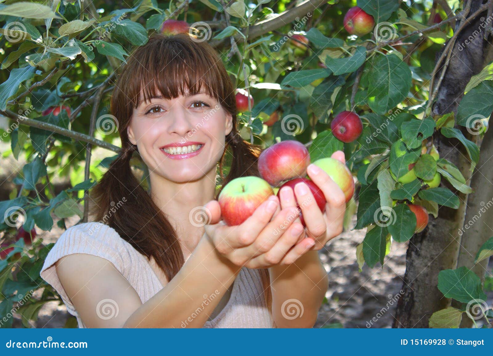 a woman offering apples