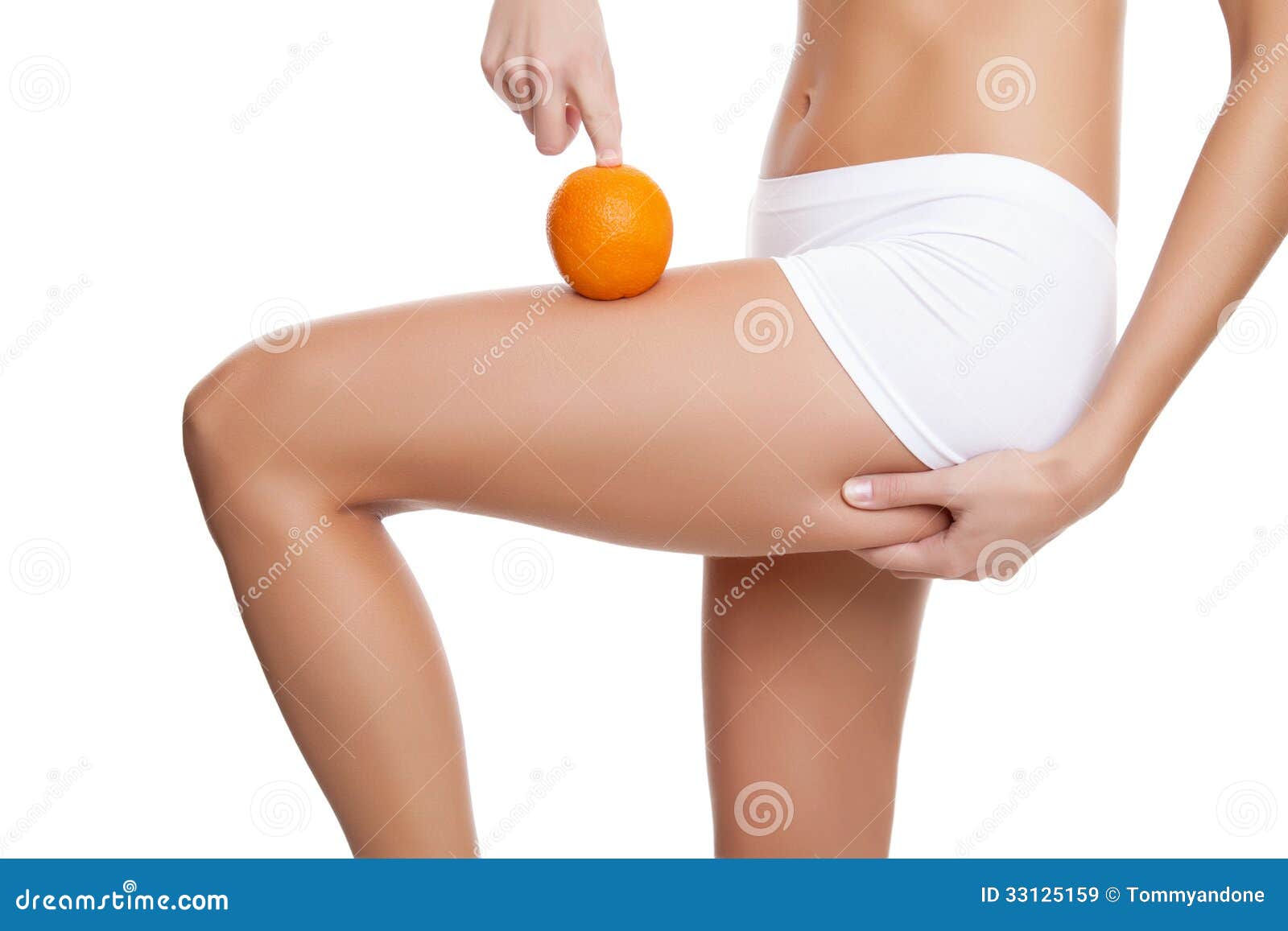 woman with an orange showing a perfect skin