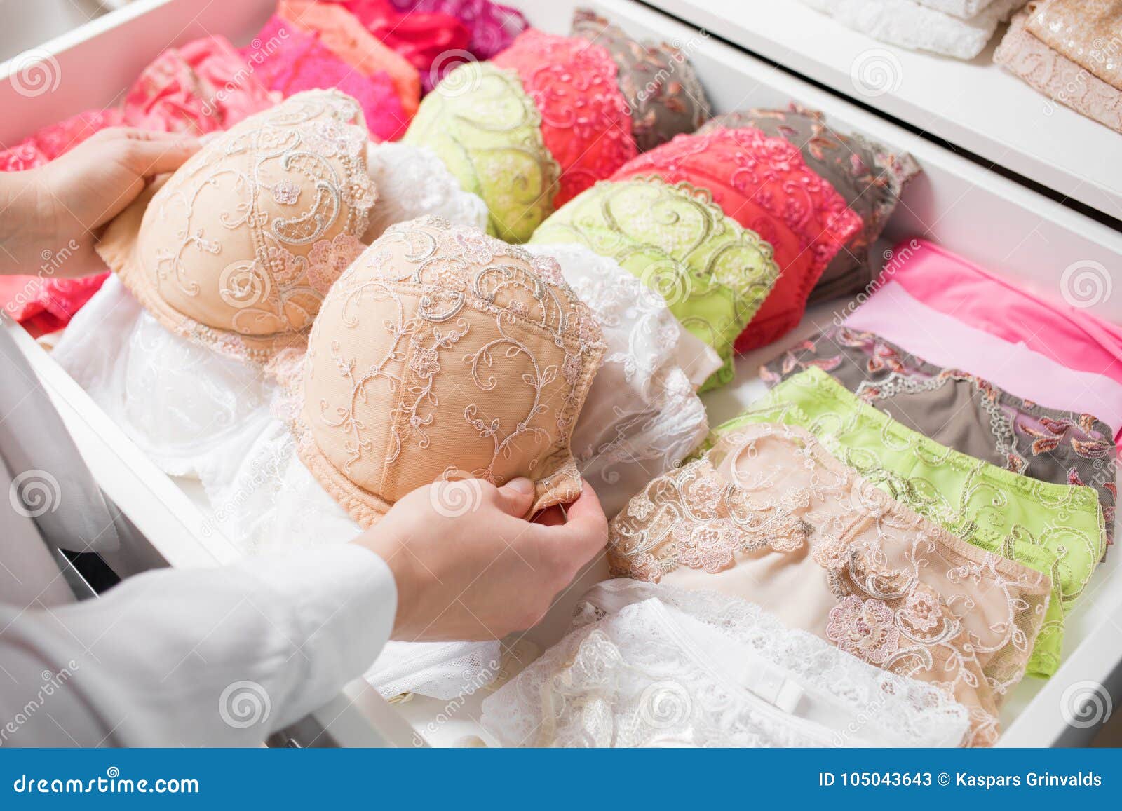 woman organizing underwear in drawer
