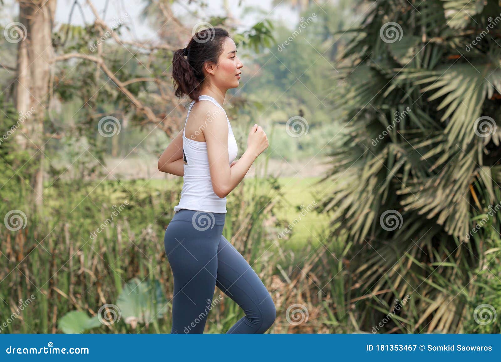 woman outdoor exercise concept the beautiful asian woman aged 20 to 25 is an athlete and a runner. running at a refreshing and rel