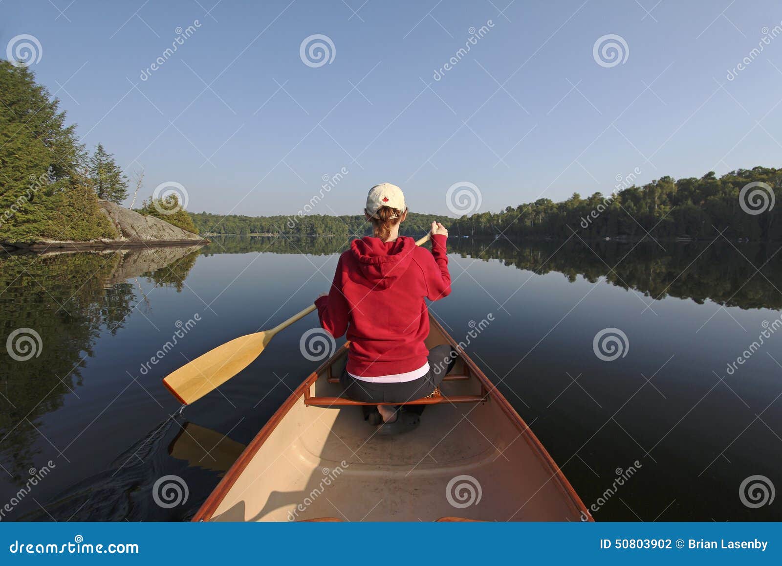 Woman Paddling A Canoe On A Northern Ontario Lake Stock Photo - Image 