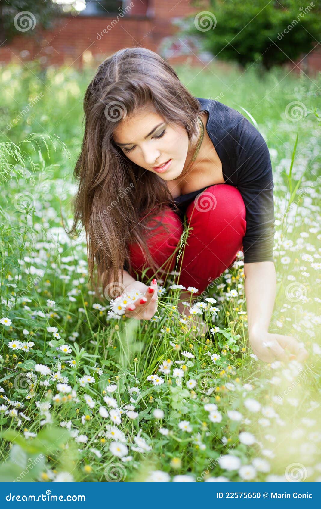 woman in park gather spring flowers