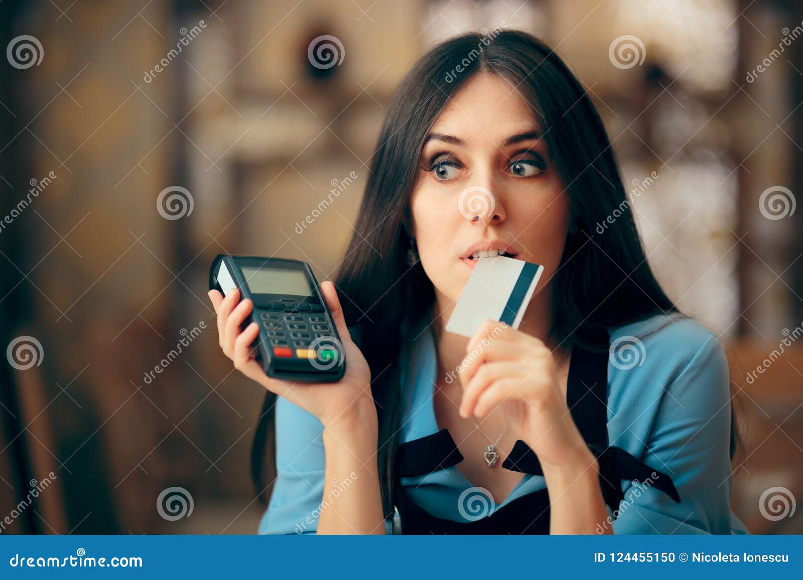 woman paying with credit card by paying pos terminal