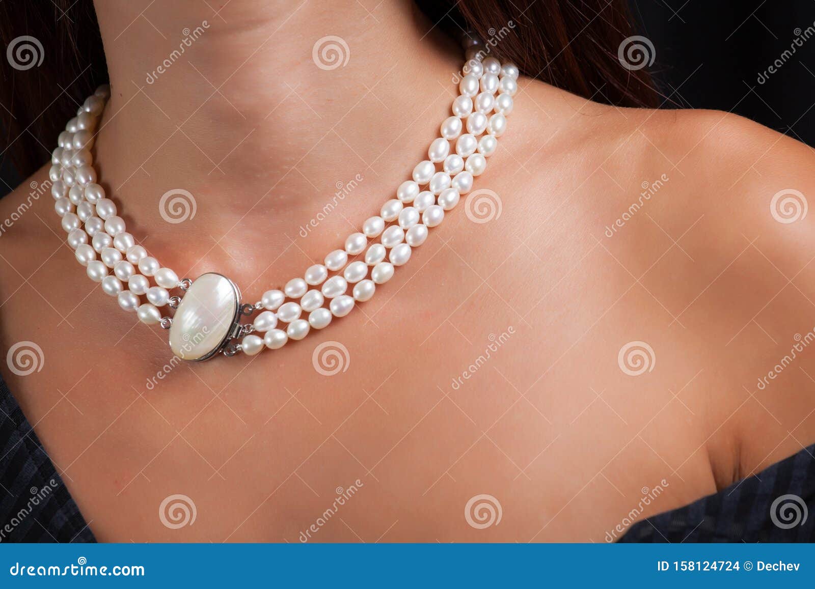 Woman with pearl necklace on her neck. Close up