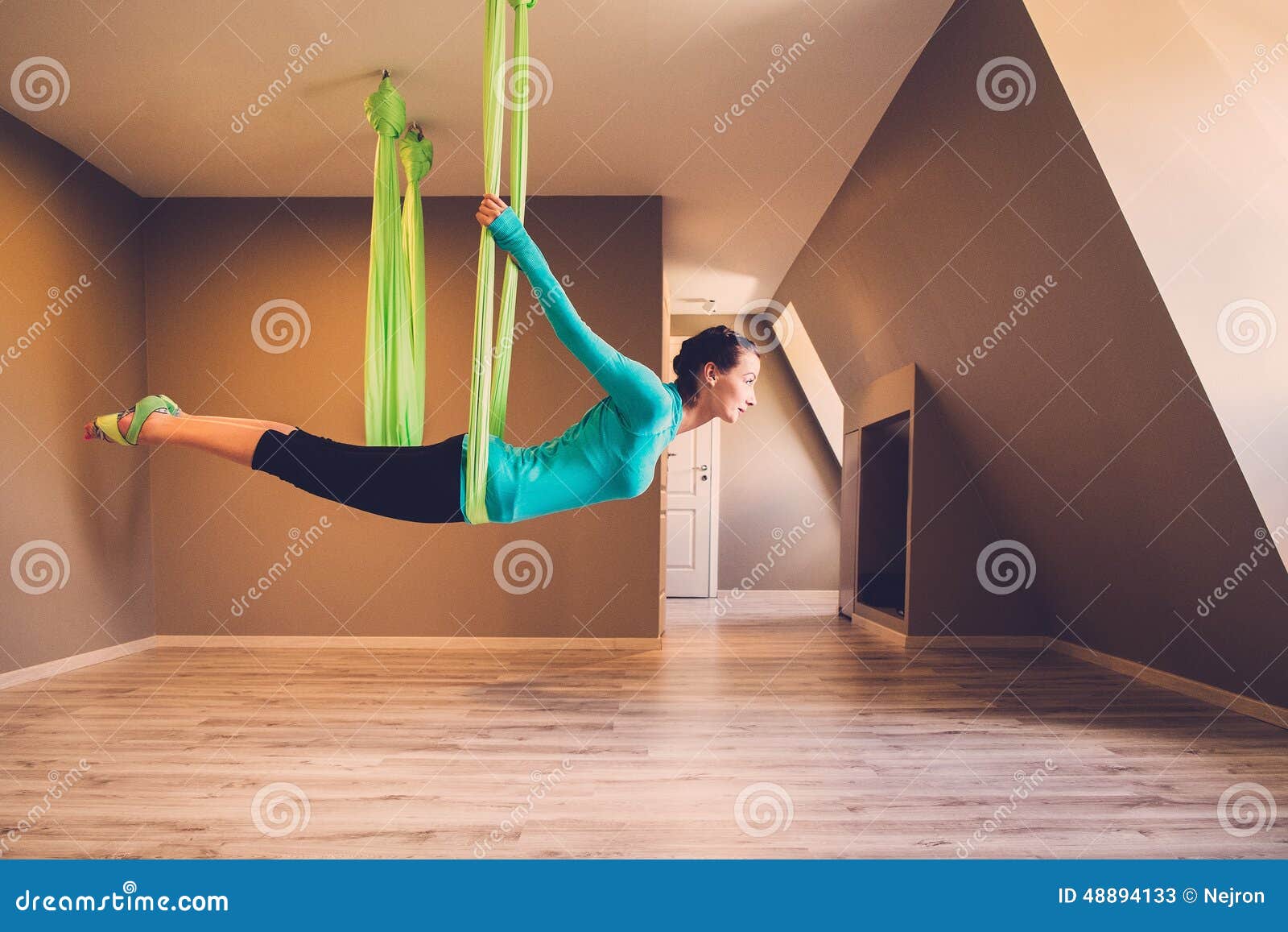 woman performing antigravity yoga