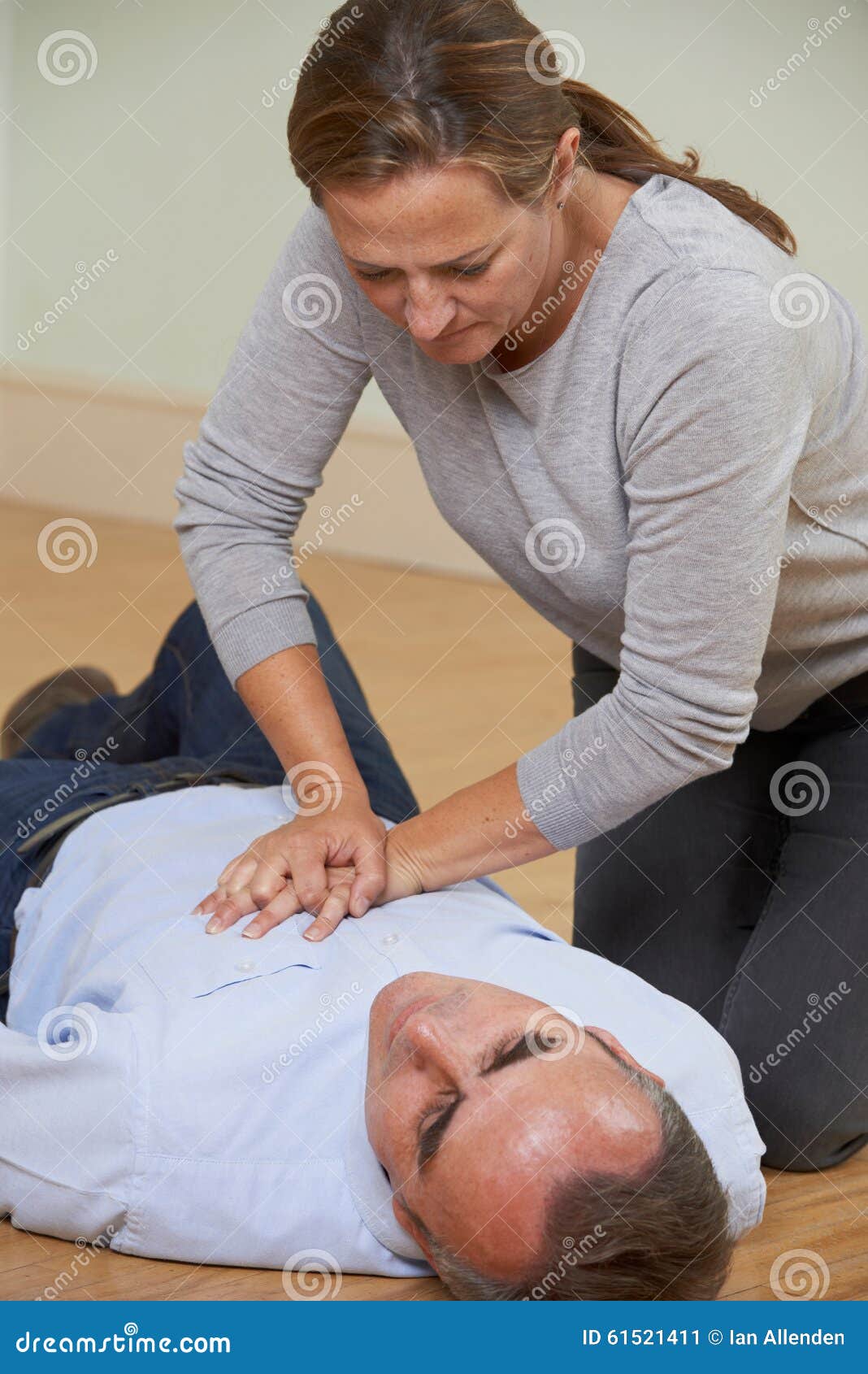 Woman Performing CPR on Man Collapsed on Floor Stock Image Image of