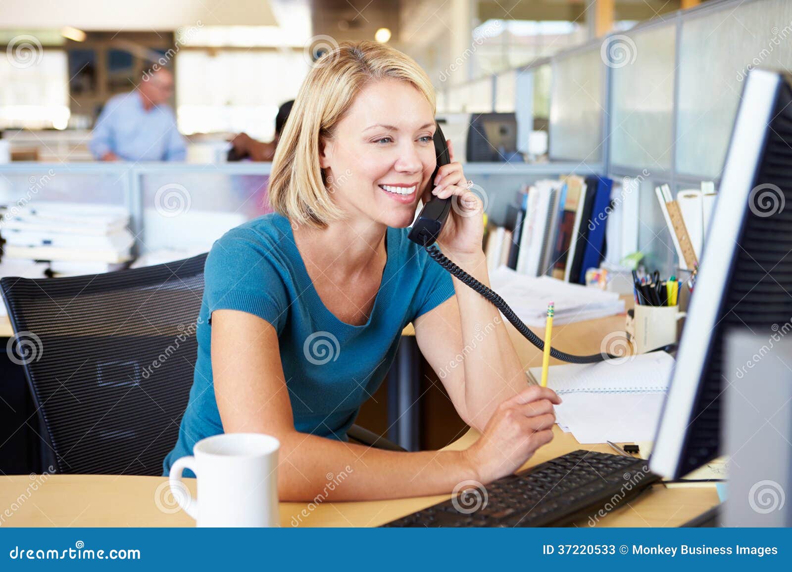 woman on phone in busy modern office