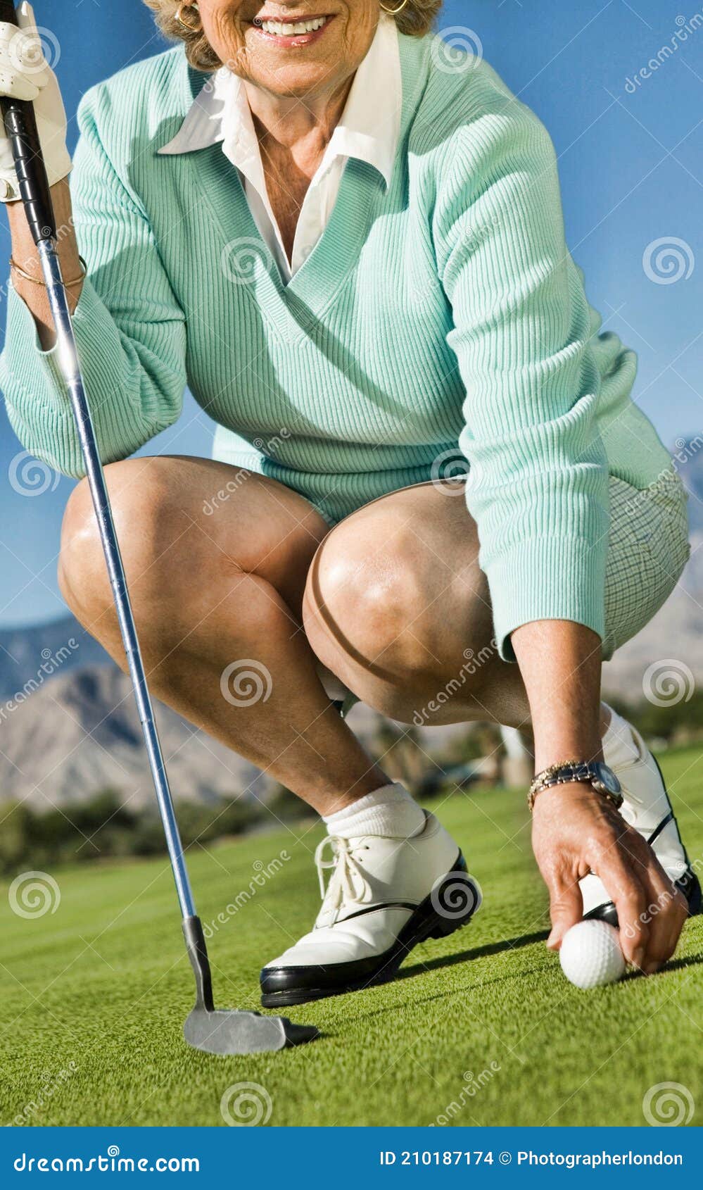 Woman Picking up Golf Ball stock photo. Image of golfer 210187174