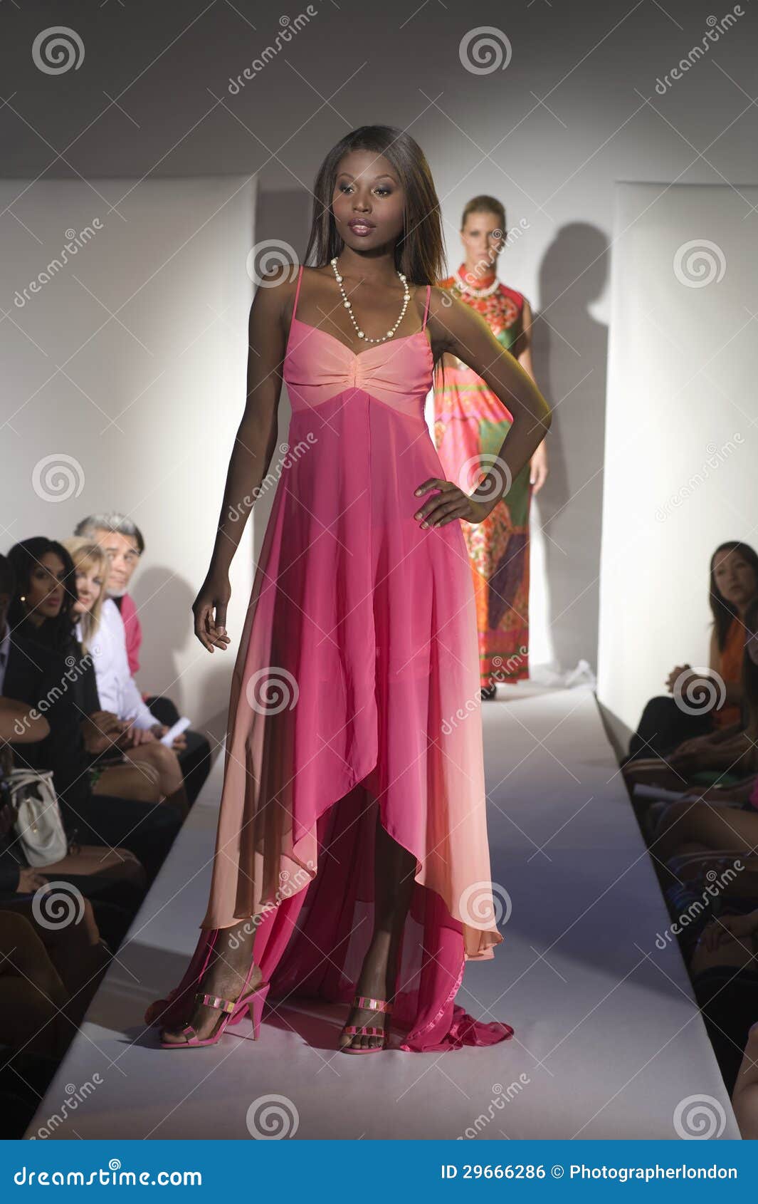 woman in pink dress on fashion catwalk