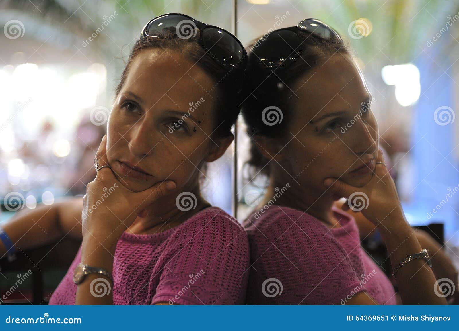 Woman in pink dress. Romantic woman in pink crochet dress with a pensive look.