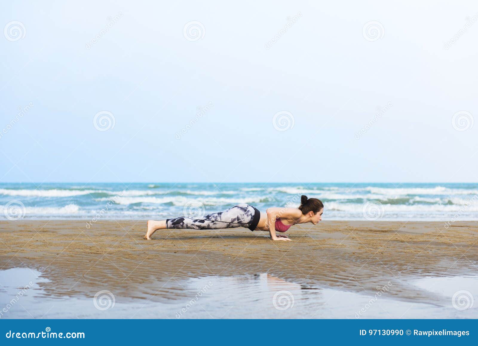 woman planking stretching flex training healthy lifestyle beach