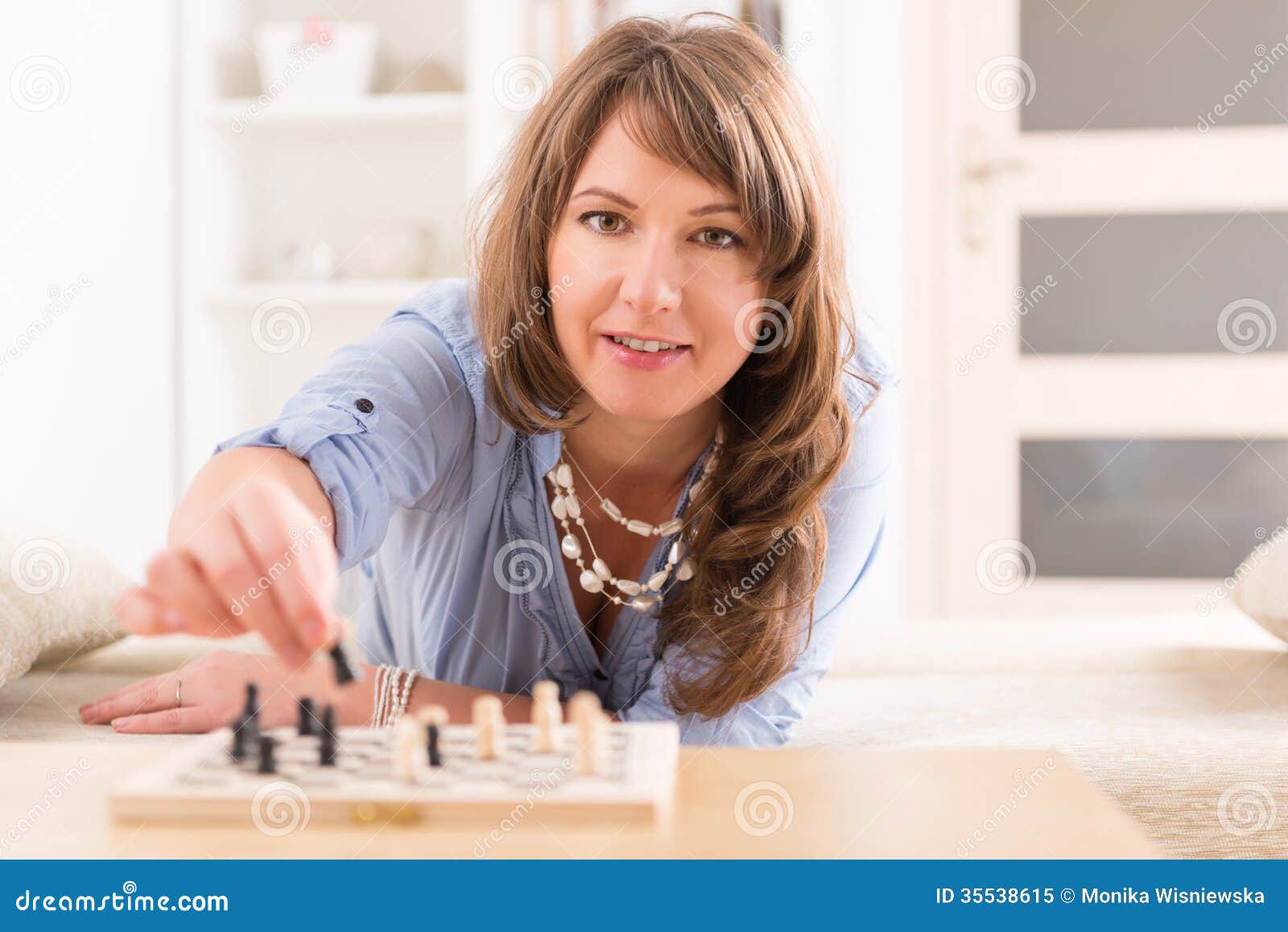 Woman playing chess thinking of next move Stock Photo - Alamy