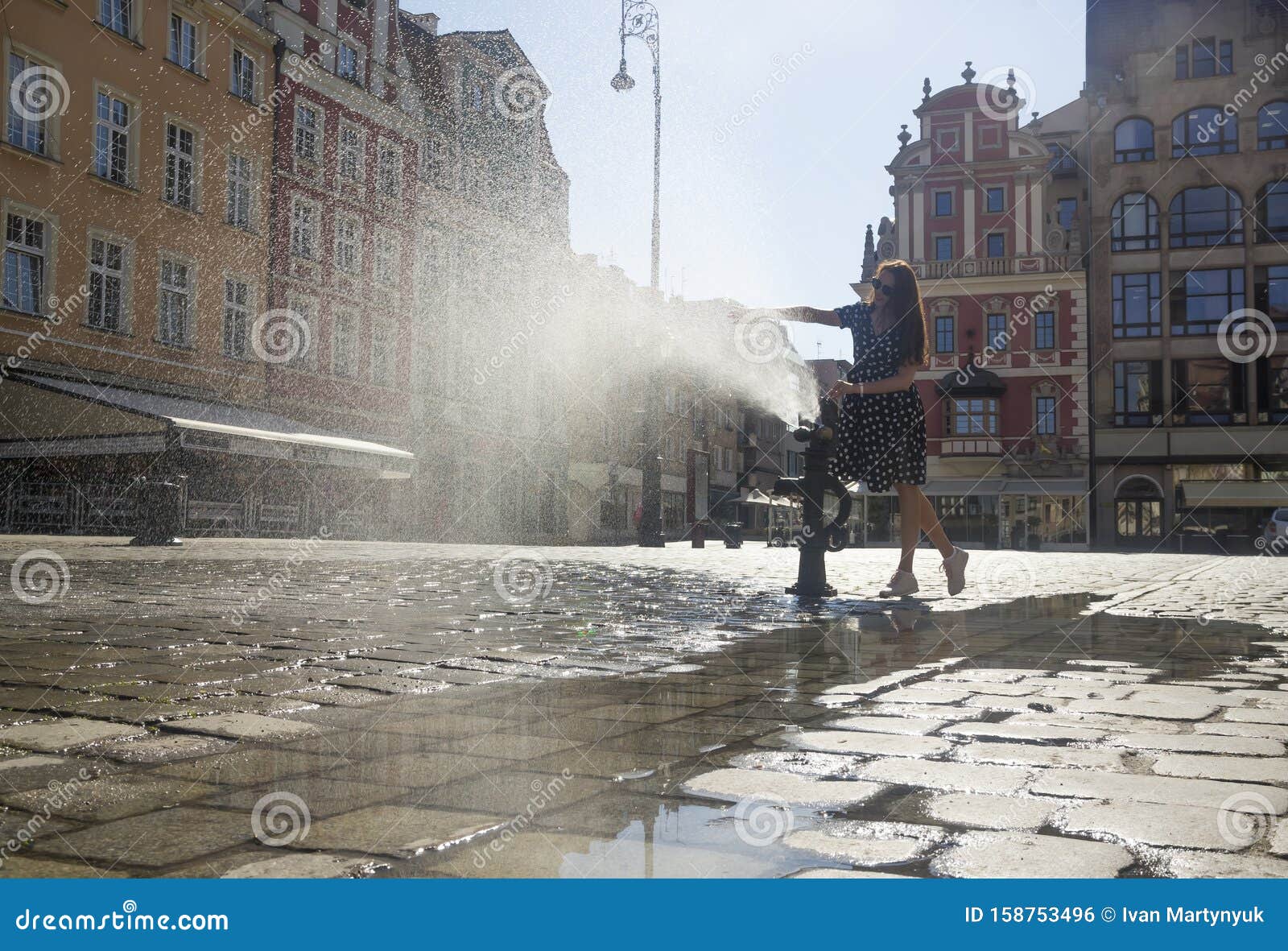 woman playing with a fountain