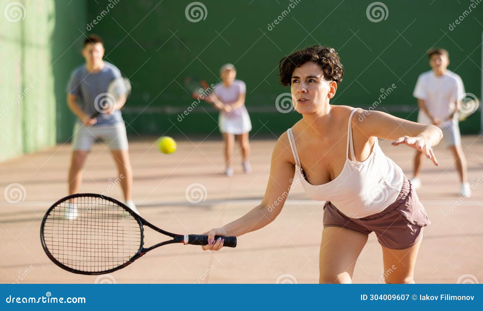 woman playing frontenis on outdoor pelota court