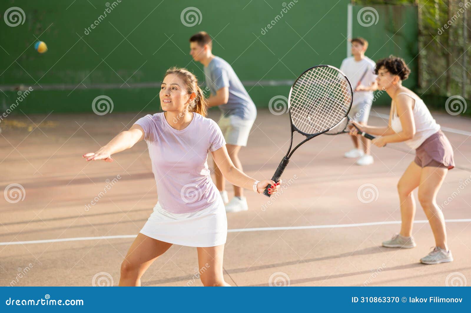 woman playing frontenis on outdoor pelota court