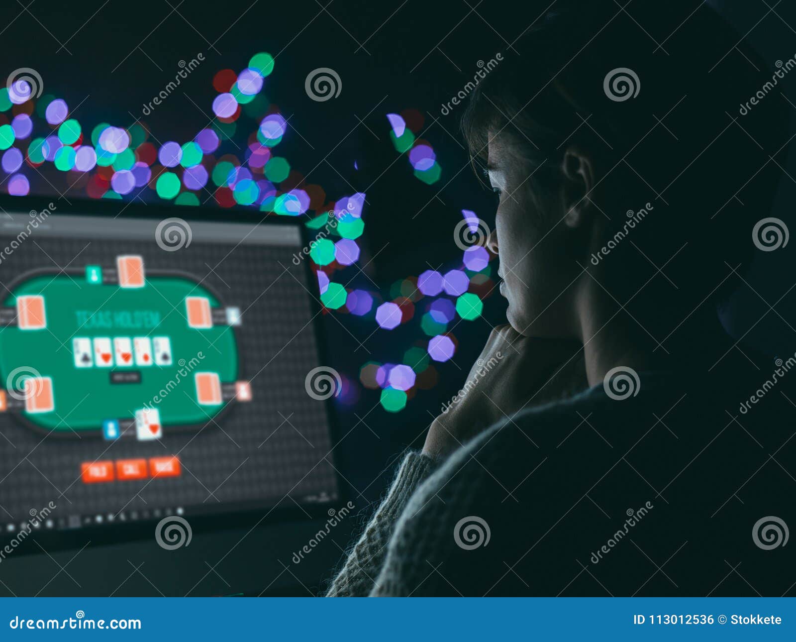 Woman playing online poker late at night