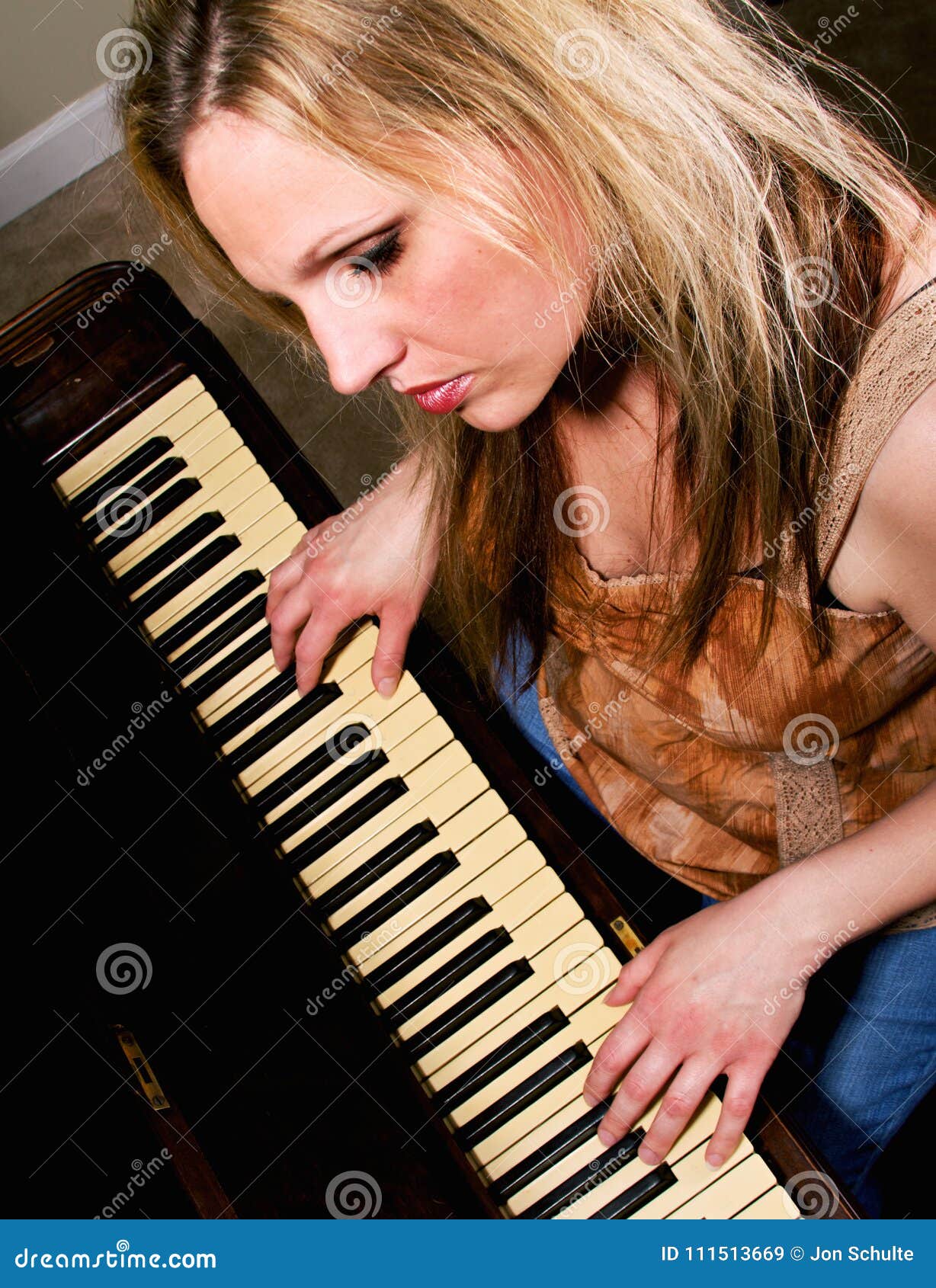A woman playing the piano stock image. Image of home - 111513669