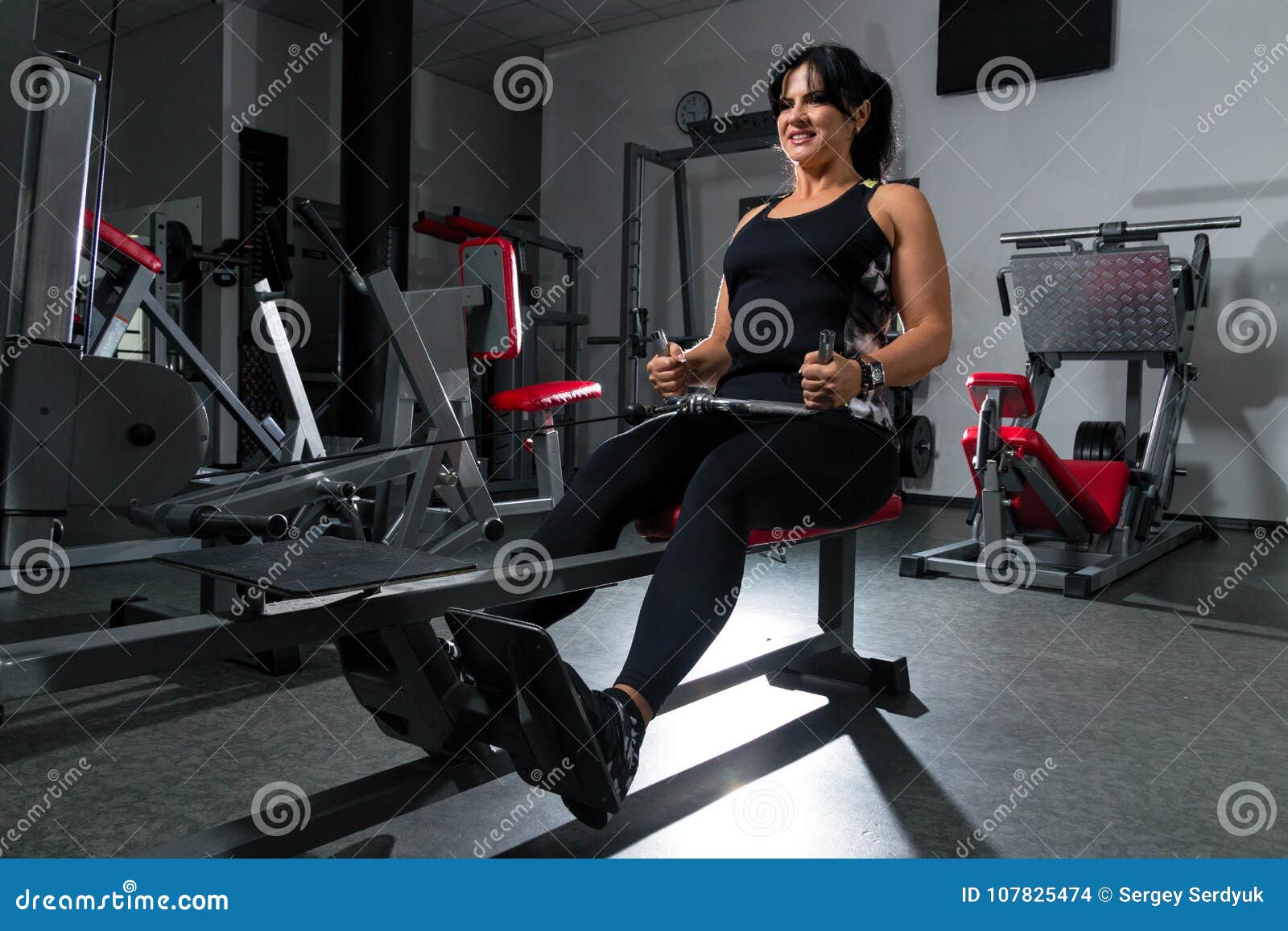 Woman plus size in gym doing exercises with running training