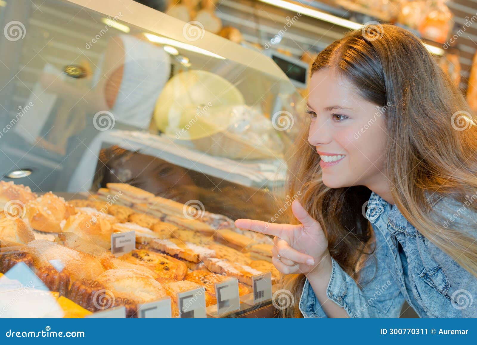 woman pointing on specific pastry