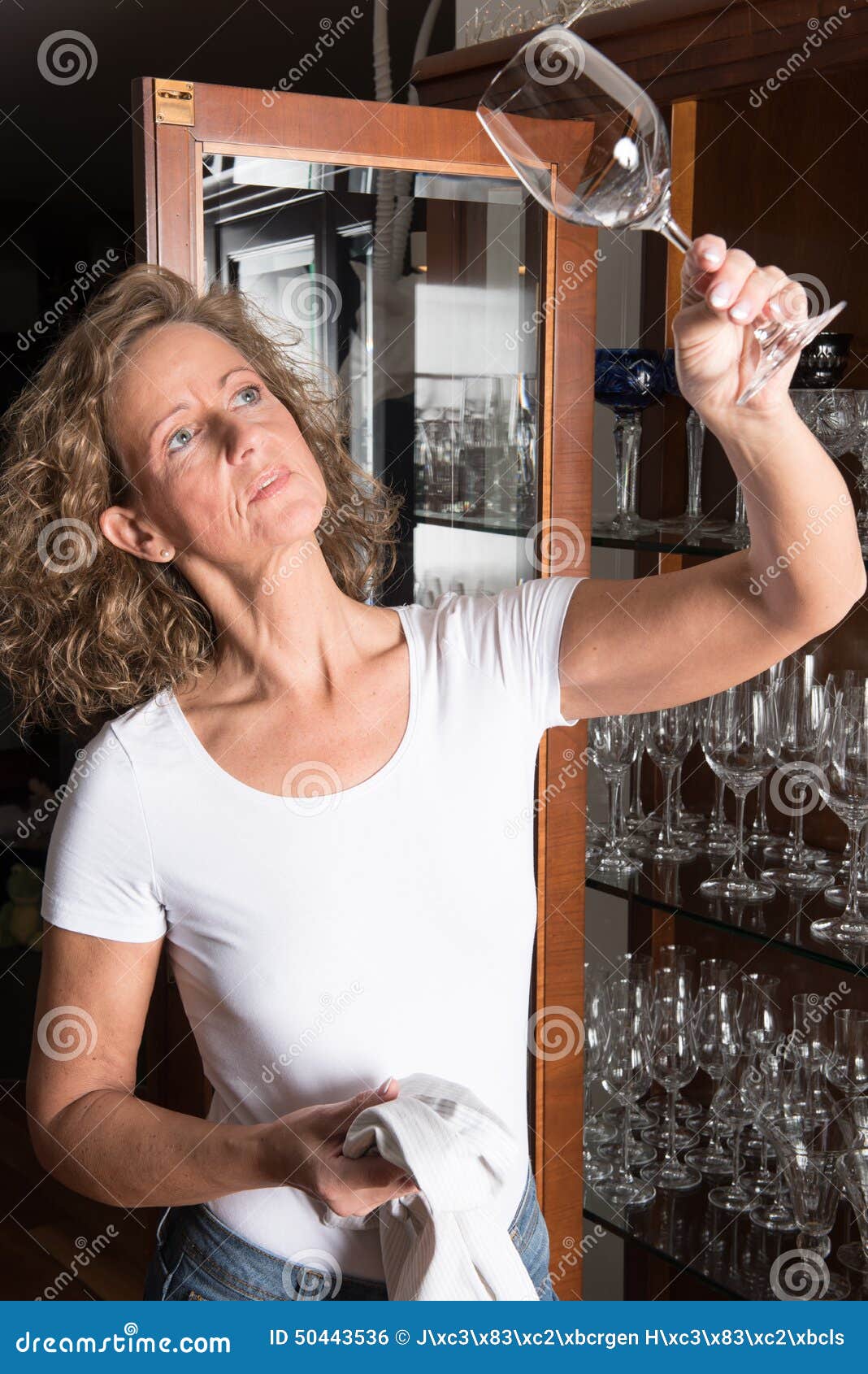Woman polishing glasses stock photo. Image of polishing 50443536