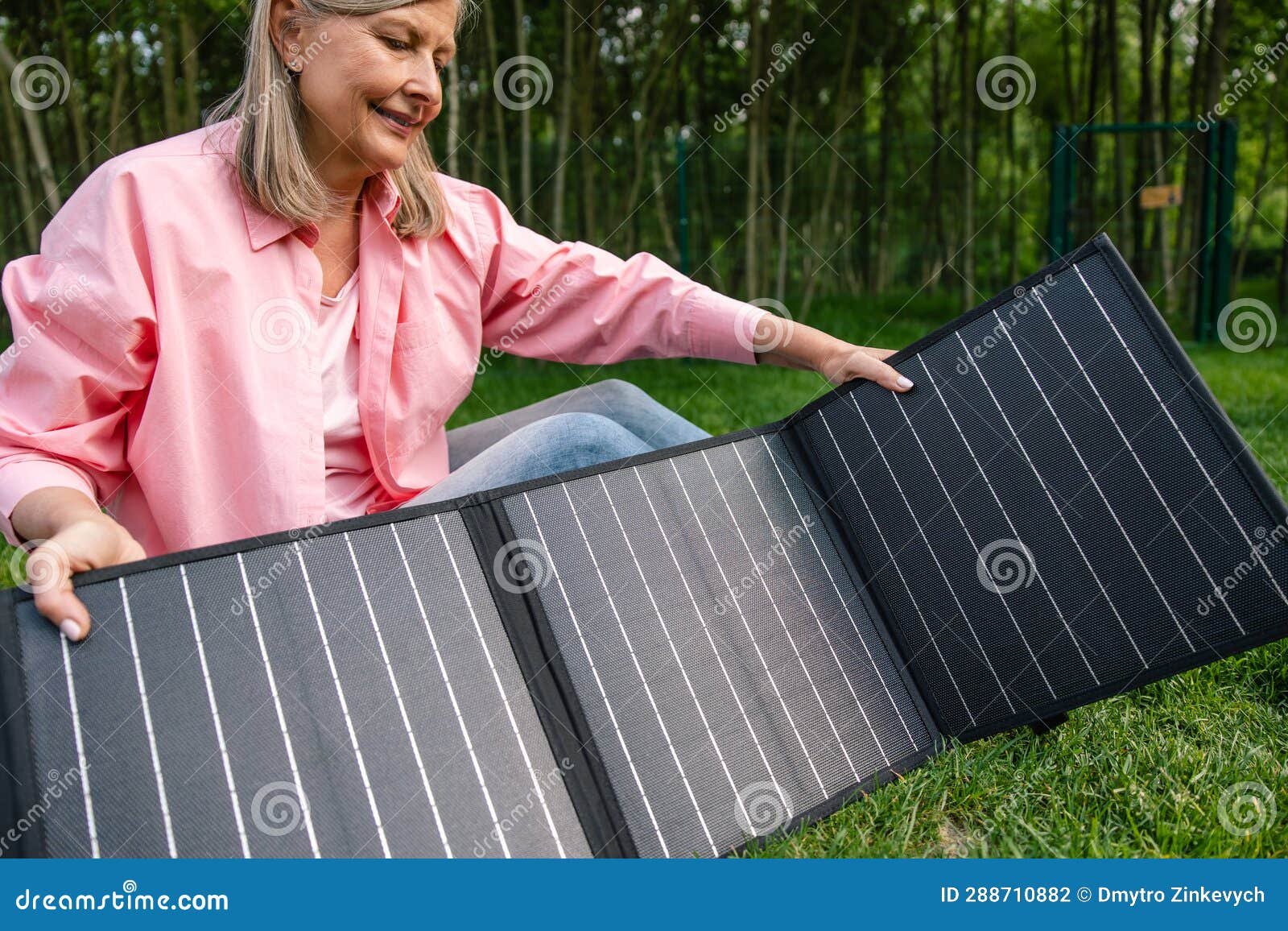 Woman with Portable Solar Panel in Yard. Stock Photo Image of holding