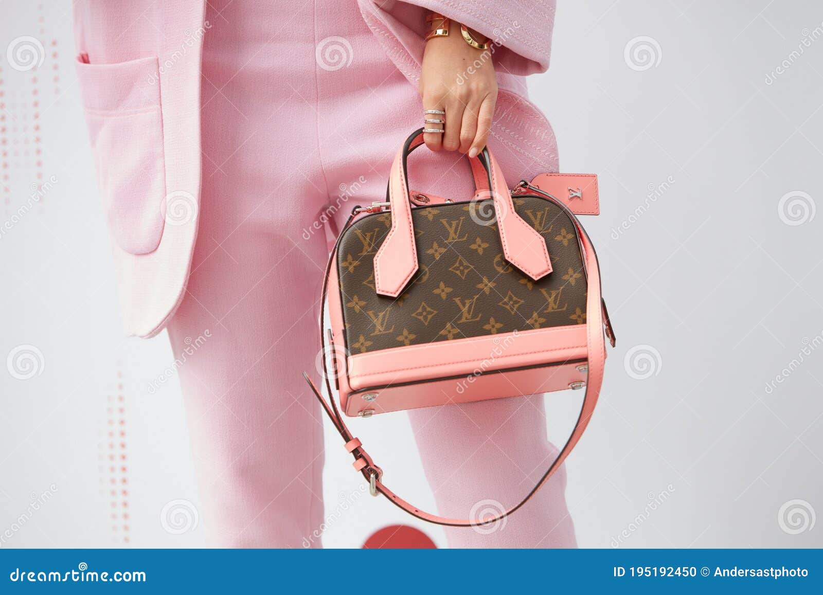 Woman Poses for Photographers with Pink and Brown Louis Vuitton