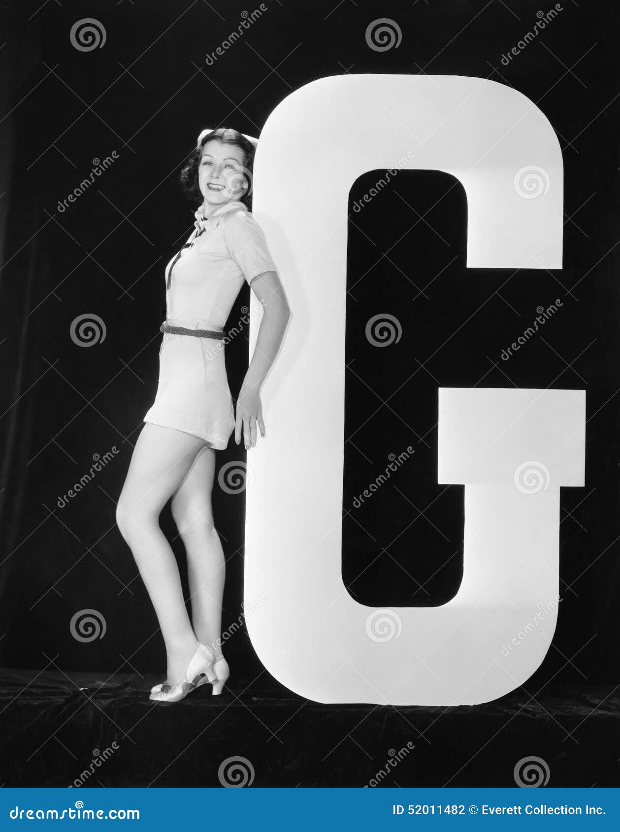 woman posing with huge letter g