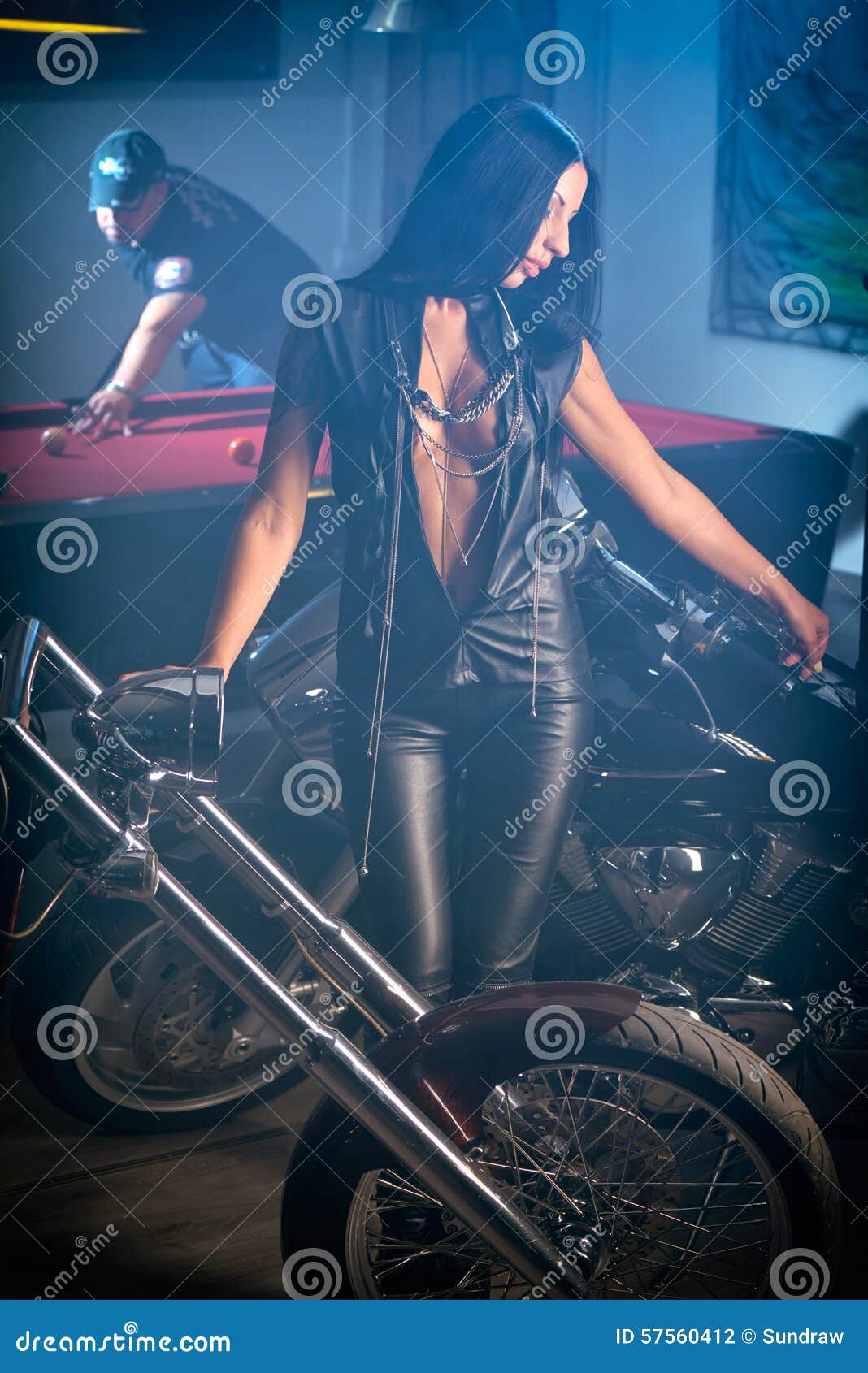 woman posing near motorbikes, man playing billiards