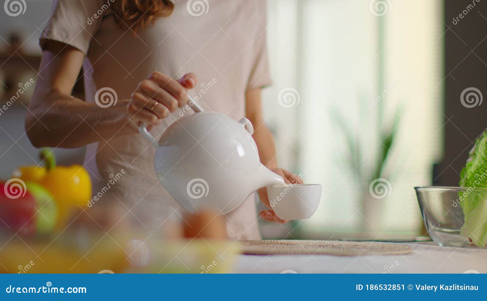 Woman Pouring Tea into Cup on Kitchen. Lady Drinking Tea at Home Stock ...