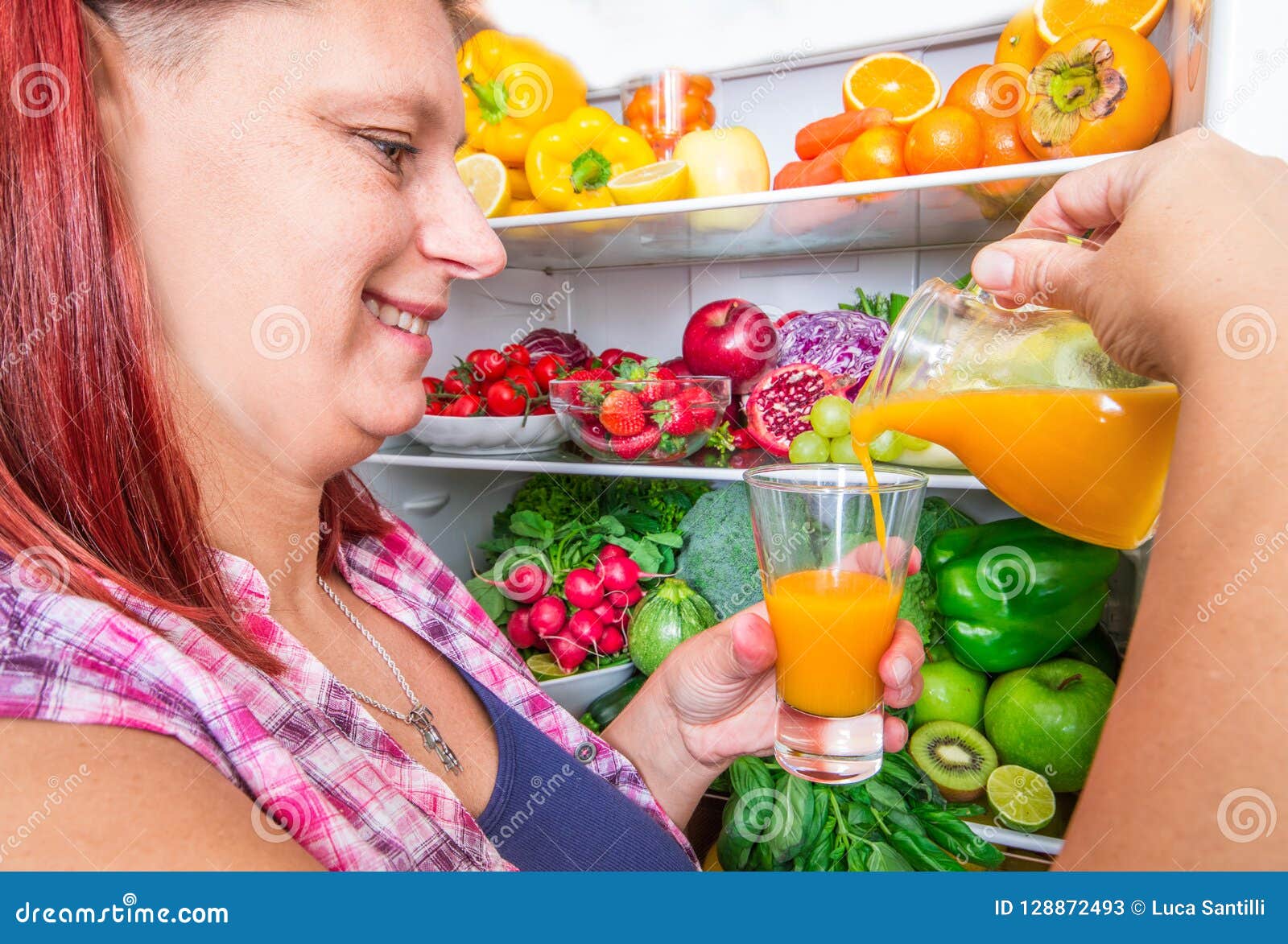 Woman that Pours Fruit Juice from the Fridge Stock Image Image of
