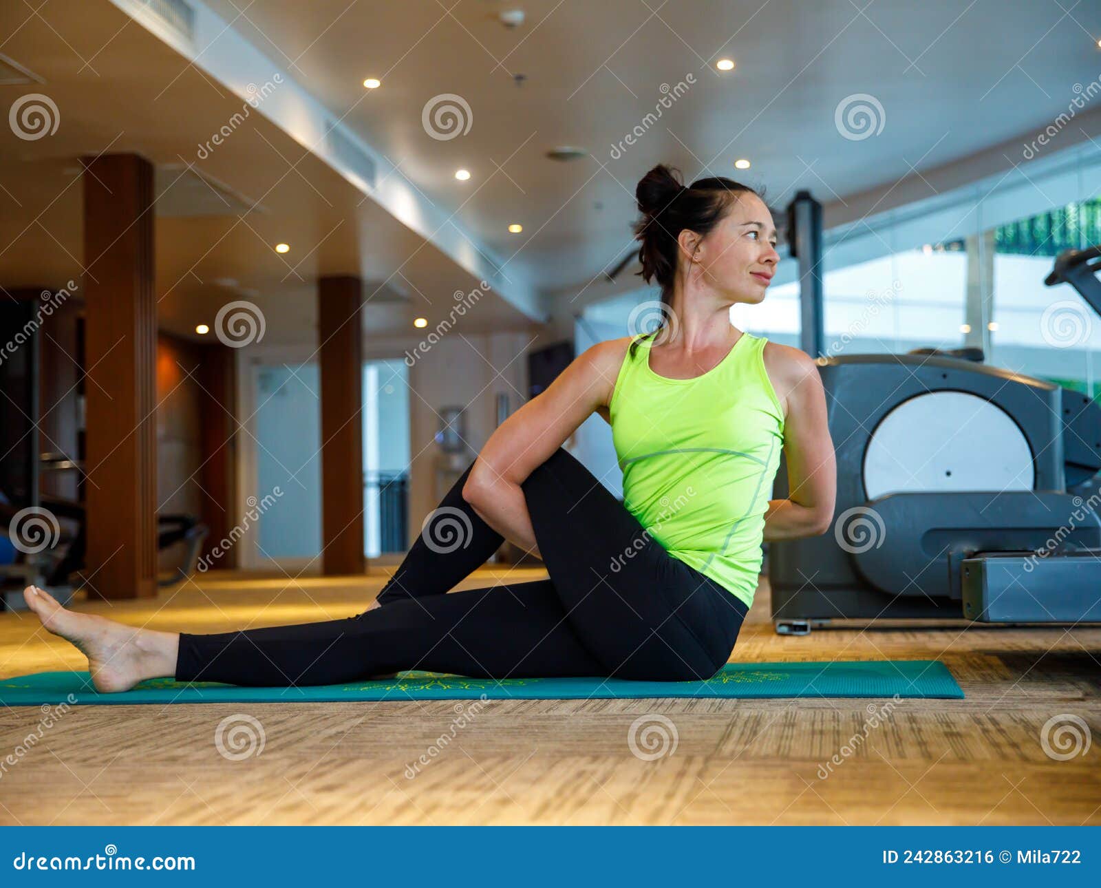 Woman practicing yoga, Ardha Matsyendrasana pose with Namaste Stock Photo -  Alamy
