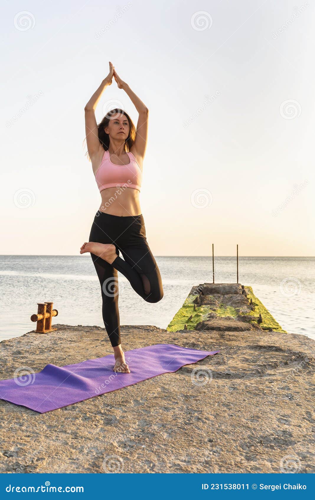 Woman standing a grateful namaste yoga pose on the beach next to the ocean  or sea in cloudy weather Zen meditation peace Sun greeting  Surya Nama  Stock Photo  Alamy