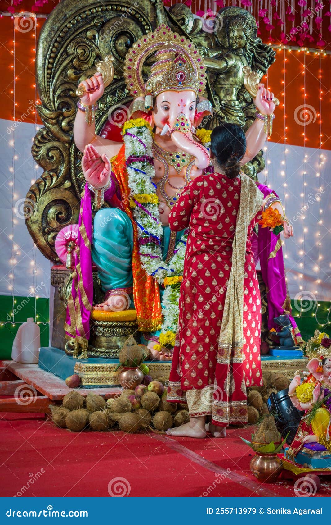 A Woman Praying before a Beautiful Idol of Lord Ganesha Editorial Stock ...
