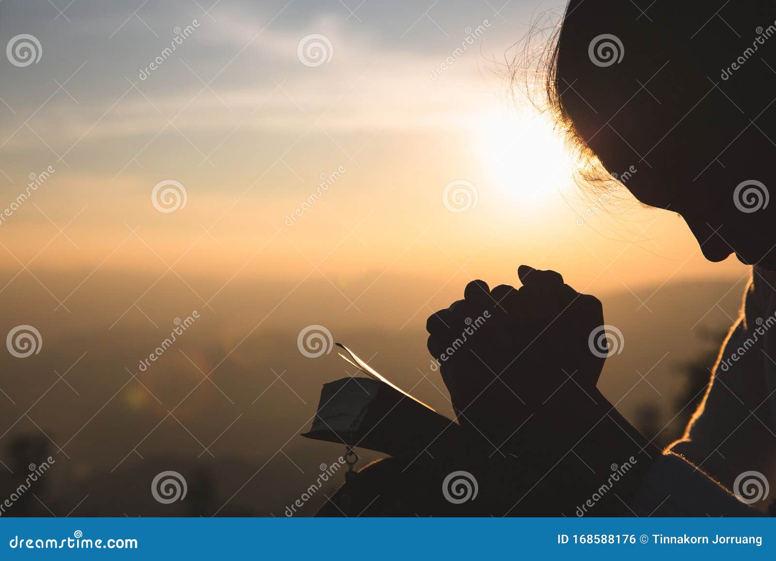 woman praying in the morning on the sunrise background. christianity concept. pray background. faith hope love concept