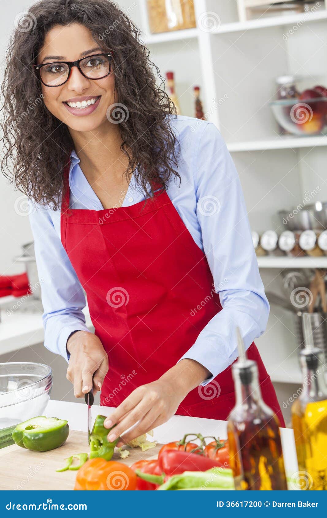 Woman Wearing Apron And Cooking Healthy Meal In The 