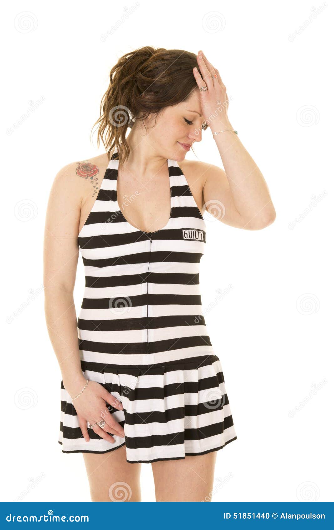 woman in prison outfit skirt with ball and chain on foot Stock Photo
