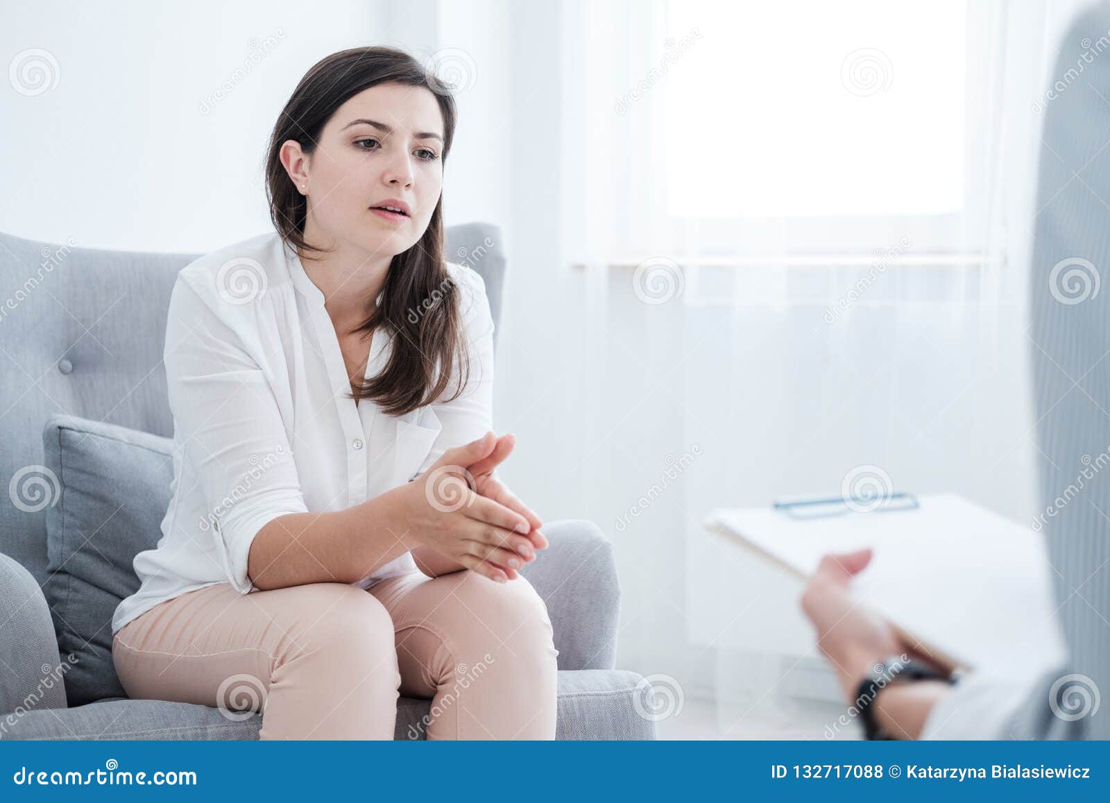 woman with problem talking to psychotherapist during therapy in the office