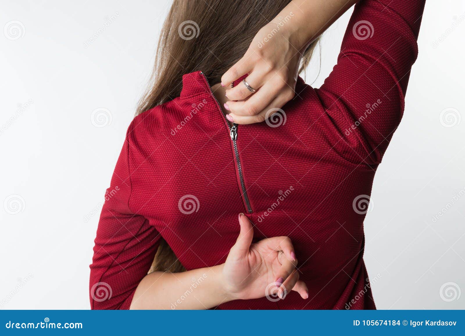 Woman Pulling the Zip Up or Down on Her Stylish Red Dress Stock Photo