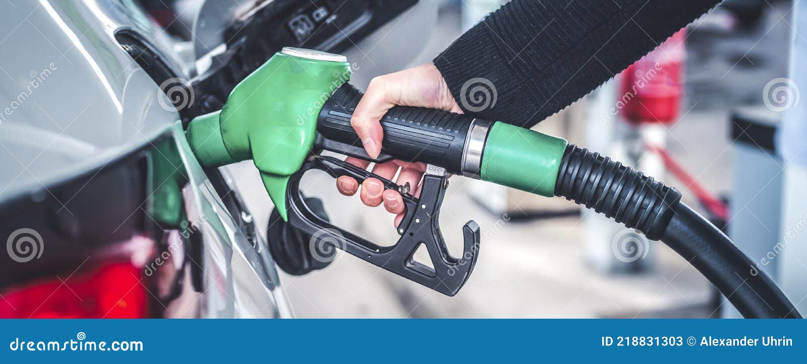 woman pumping gasoline fuel in car at gas station.