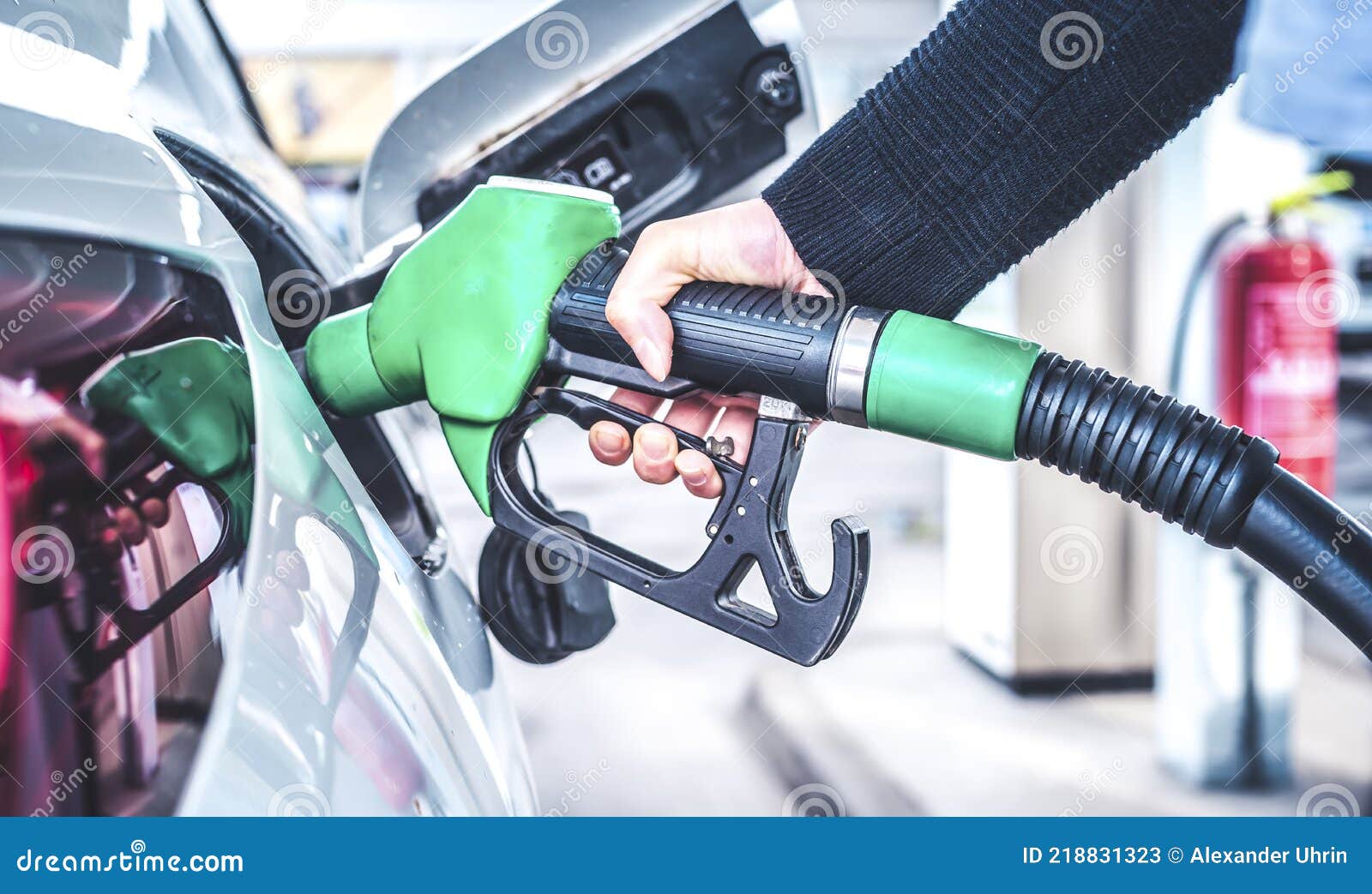 woman pumping gasoline fuel in car at gas station.